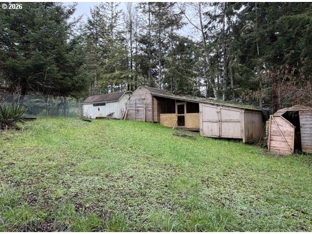 64294 Penny Road Coos Bay, OR 97420 - Photo 26 of 26 a view of a house with backyard and garden
