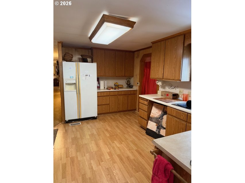 64294 Penny Road Coos Bay, OR 97420 - Photo 10 of 26 a kitchen with a refrigerator and a stove