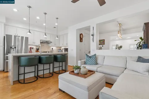 a living room kitchen with furniture and kitchen view