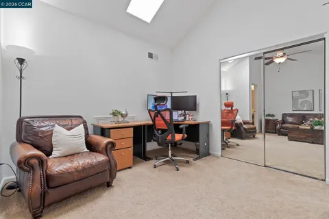 a view of a livingroom with workspace and a couch