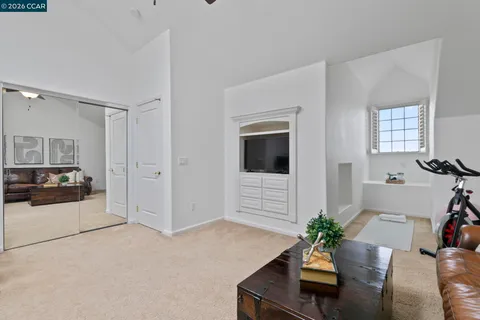 a living room with furniture potted plant and windows