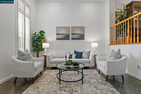a living room with furniture potted plant and a window