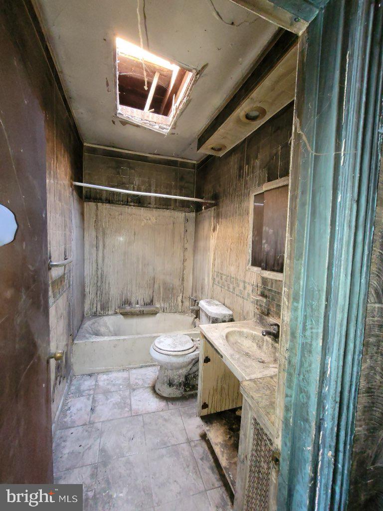 2238 Pierce Street Philadelphia, PA 19145 - Photo 8 of 9 a bathroom with a sink a toilet and shower