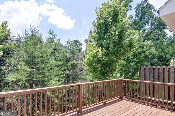 a view of balcony with deck and trees