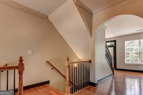 a view of an entryway with wooden floor