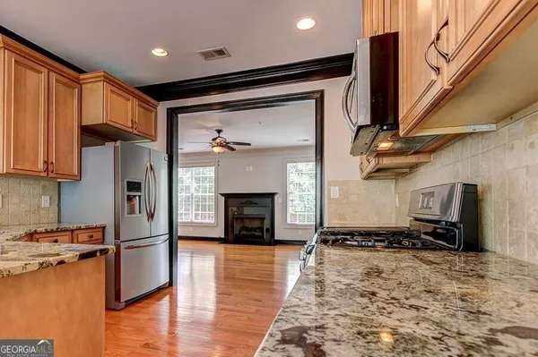 a view of kitchen with refrigerator and window