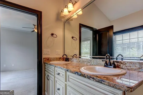 a bathroom with a double vanity sink and a mirror