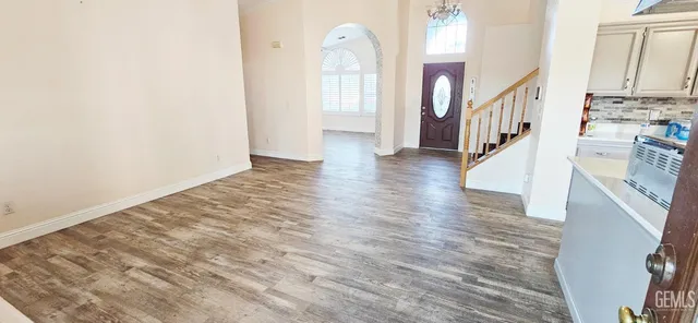 a bathroom with a sink a toilet a mirror and shower