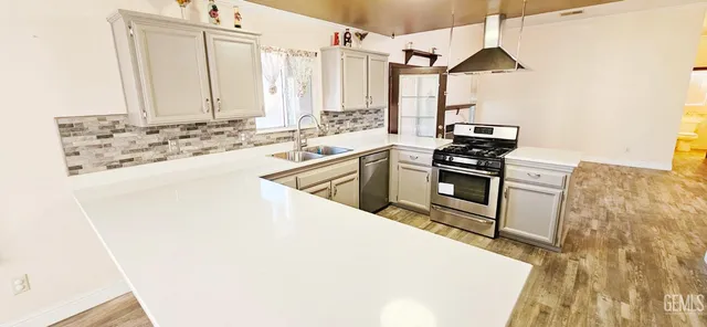 a kitchen with sink stove and white cabinets