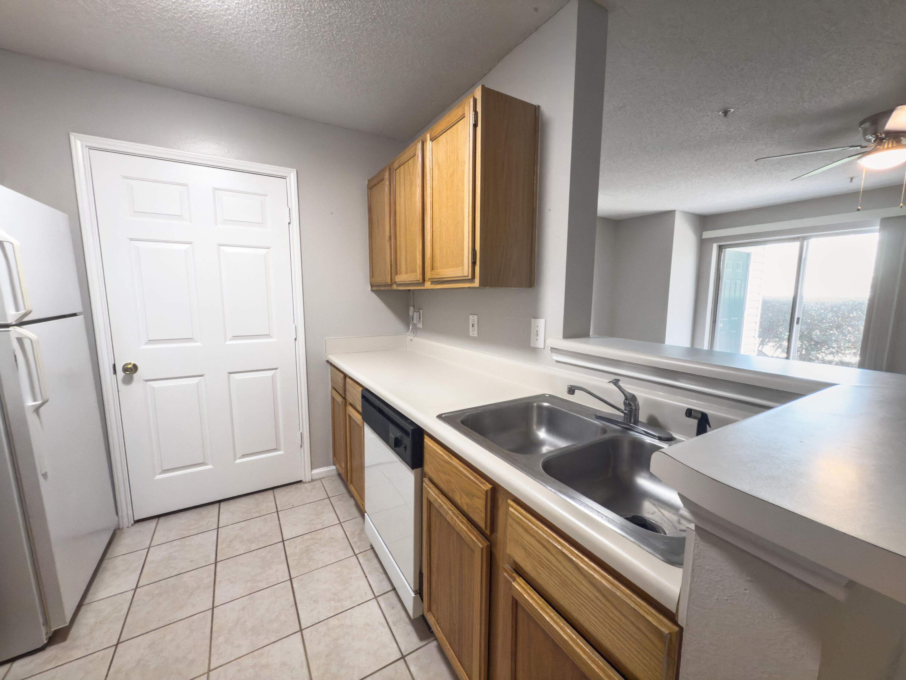 4009 Dancing Cloud Court, Unit 28 Destin, FL 32541 - Photo 11 of 25 a kitchen with a sink stove and cabinets