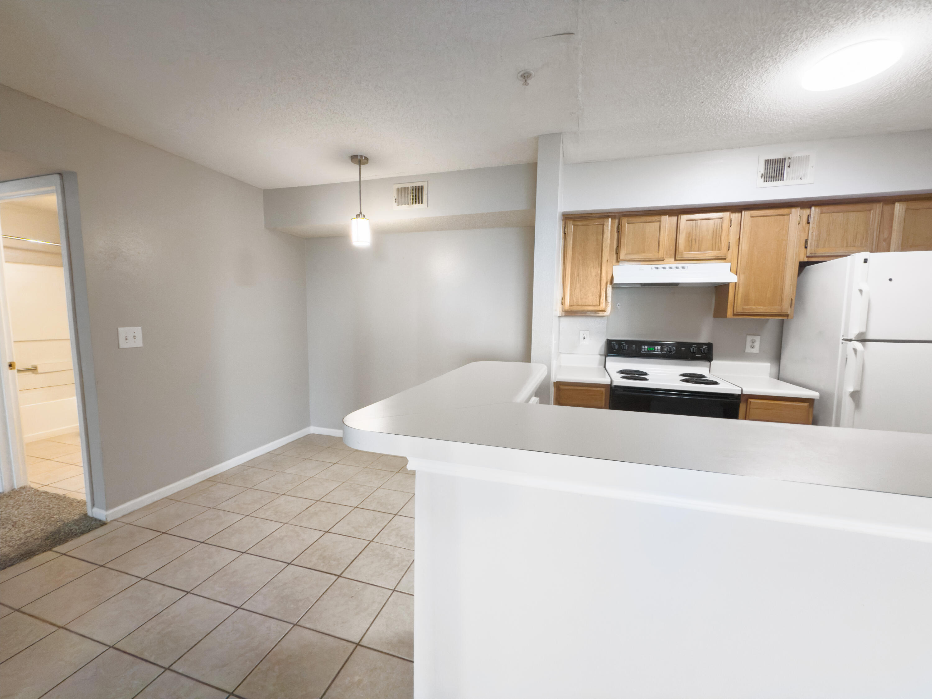 4009 Dancing Cloud Court, Unit 28 Destin, FL 32541 - Photo 13 of 25 a kitchen with kitchen island a stove a sink and a refrigerator