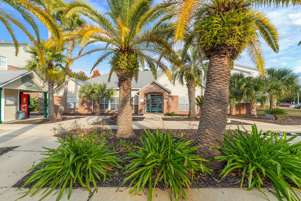 4009 Dancing Cloud Court, Unit 28 Destin, FL 32541 - Photo 3 of 25 a house with palm tree in front of it