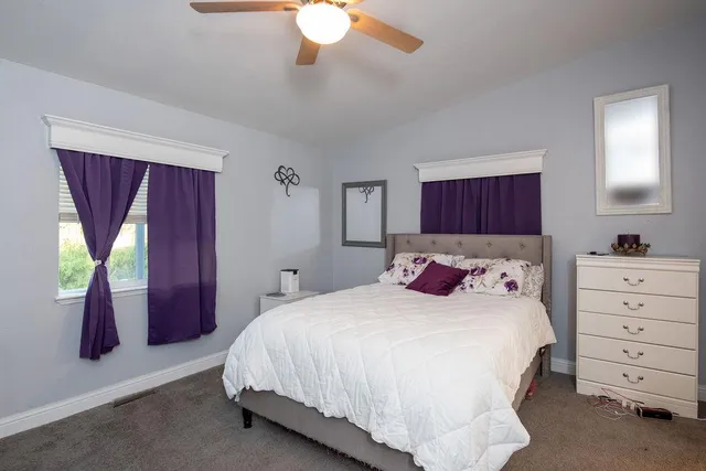 a view of a livingroom with furniture hardwood floor and a kitchen