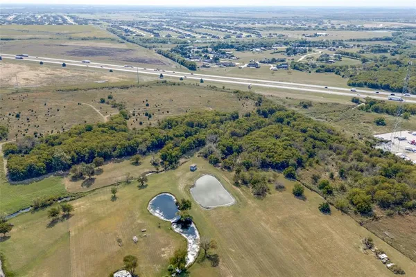 an aerial view of a house with a yard basket ball court and outdoor seating