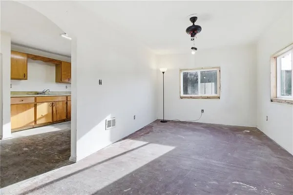 an empty room with windows and closet