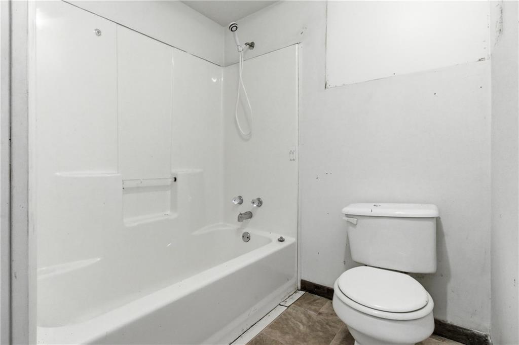 399 Cherry Street Cherry Tree, PA 15724 - Photo 9 of 24 a white toilet sitting next to a bath tub