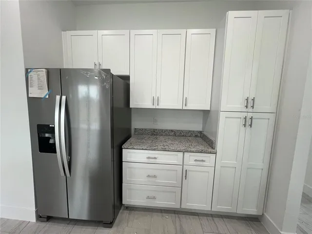 a kitchen with cabinets and stainless steel appliances
