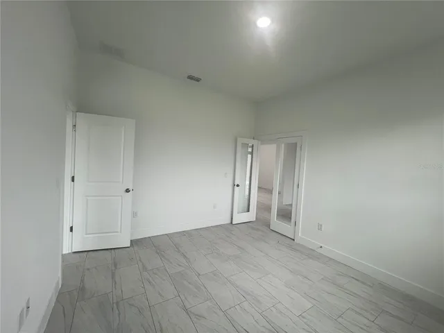 a view of an empty room and wooden floor