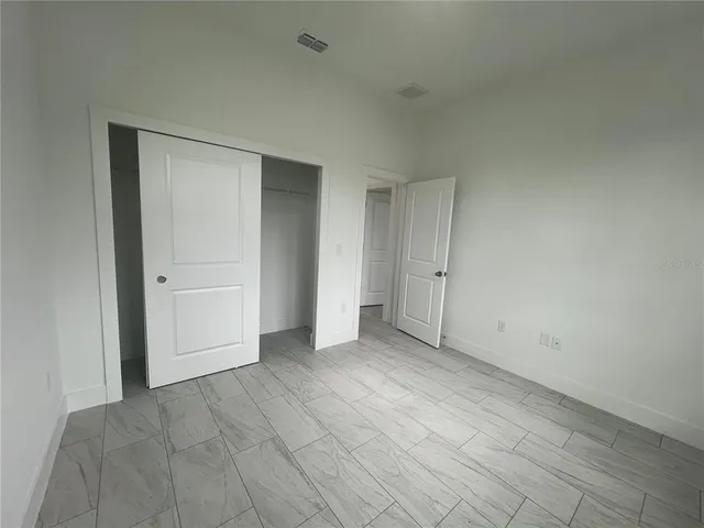 an empty room with an entrance to other room