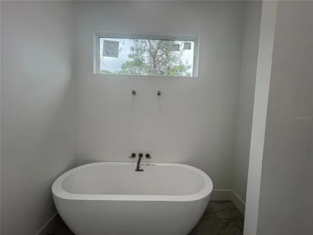 a white bath tub sitting in a bathroom