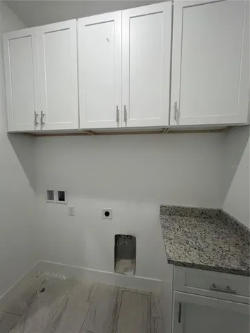 a bathroom with a granite countertop white and white cabinets