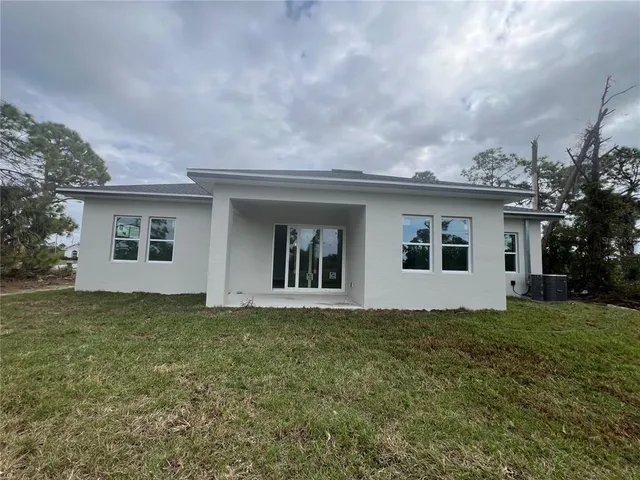 a front view of house with yard and trees