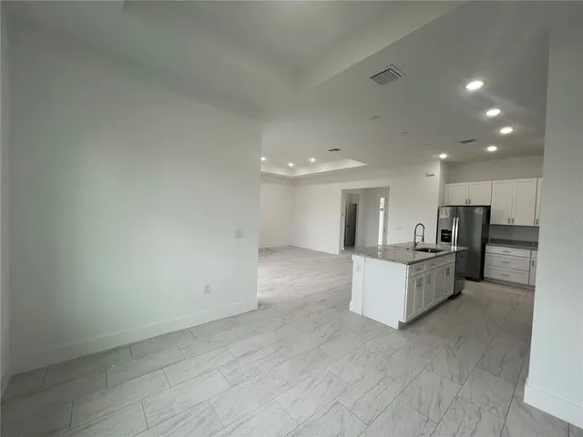 a view of kitchen appliances and cabinets