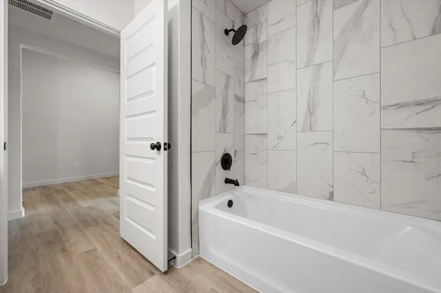 a bathroom with a bathtub and shower
