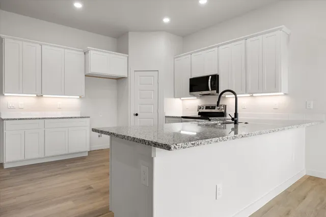 a kitchen with a sink and cabinets