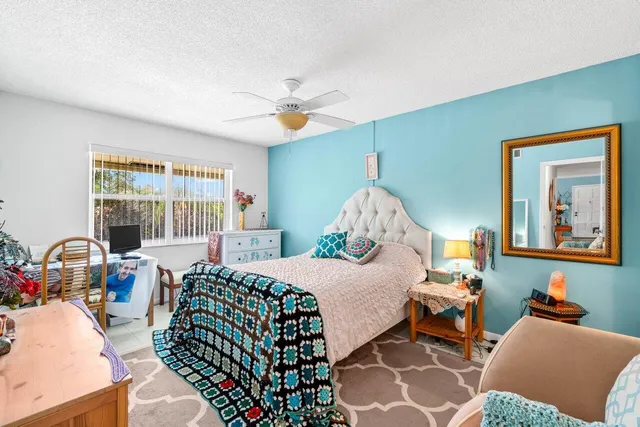 a bedroom with a bed couch and a window