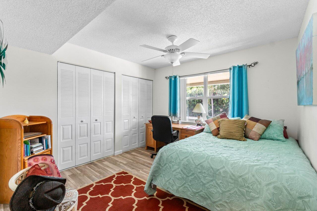 1124 Northwest 13th Street, Unit 204A Boca Raton, FL 33486 - Photo 15 of 30 a bedroom with a bed and a window