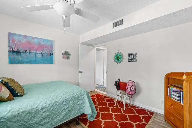 a bedroom with a bed and a painting on the wall