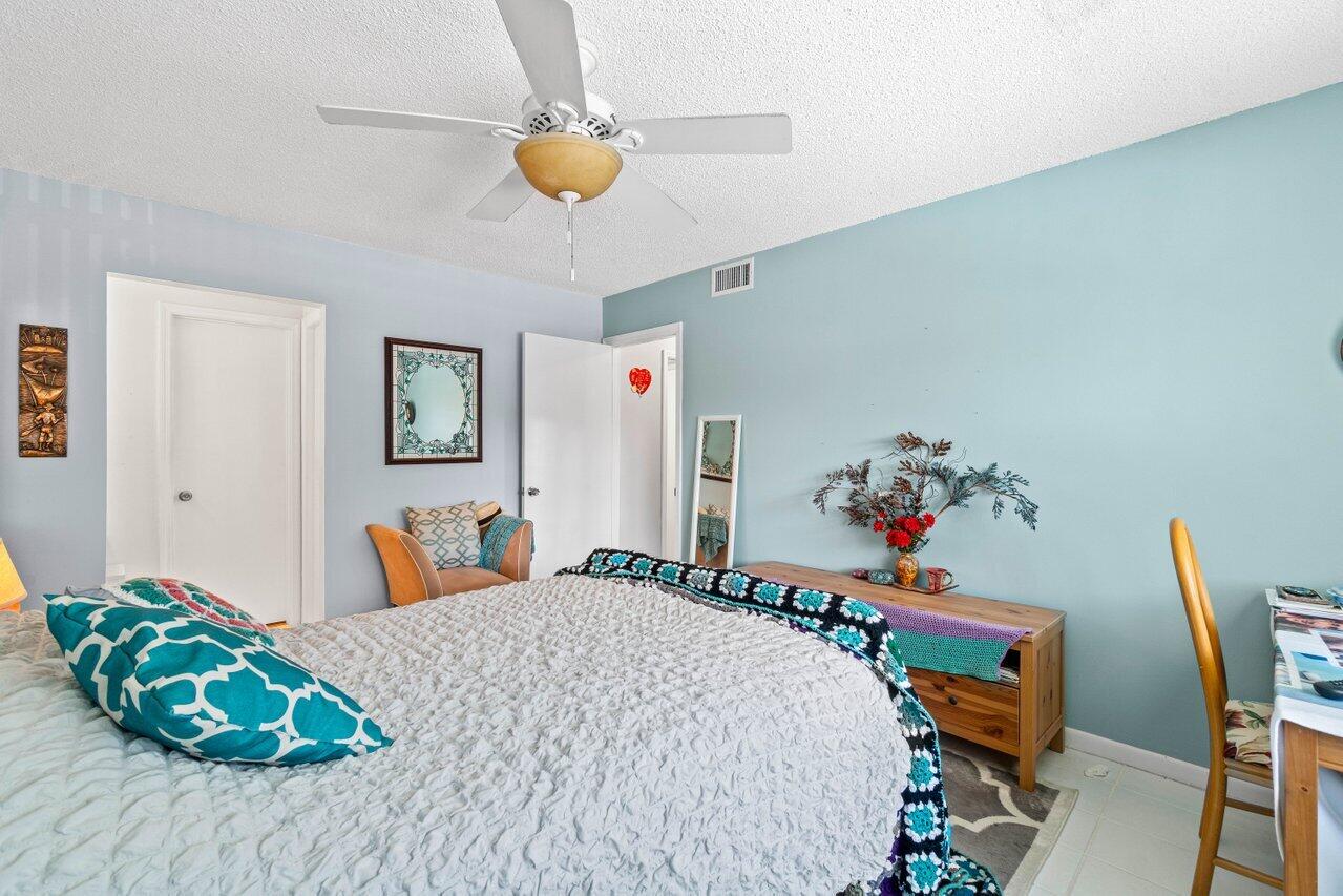 1124 Northwest 13th Street, Unit 204A Boca Raton, FL 33486 - Photo 18 of 30 a bedroom with furniture and a wooden floor