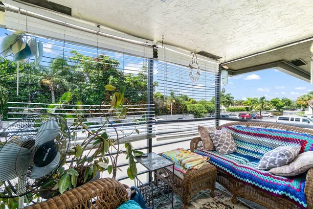 a roof deck with couches and potted plants