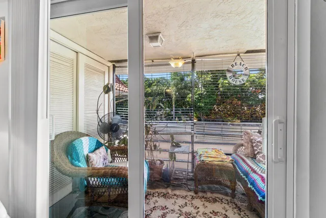 a balcony with table and chairs