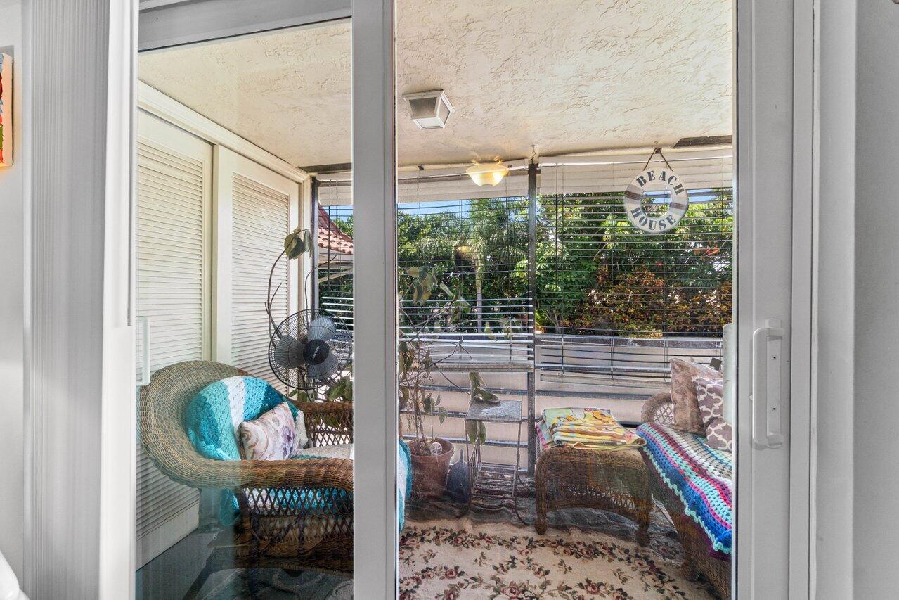 1124 Northwest 13th Street, Unit 204A Boca Raton, FL 33486 - Photo 22 of 30 a balcony with table and chairs