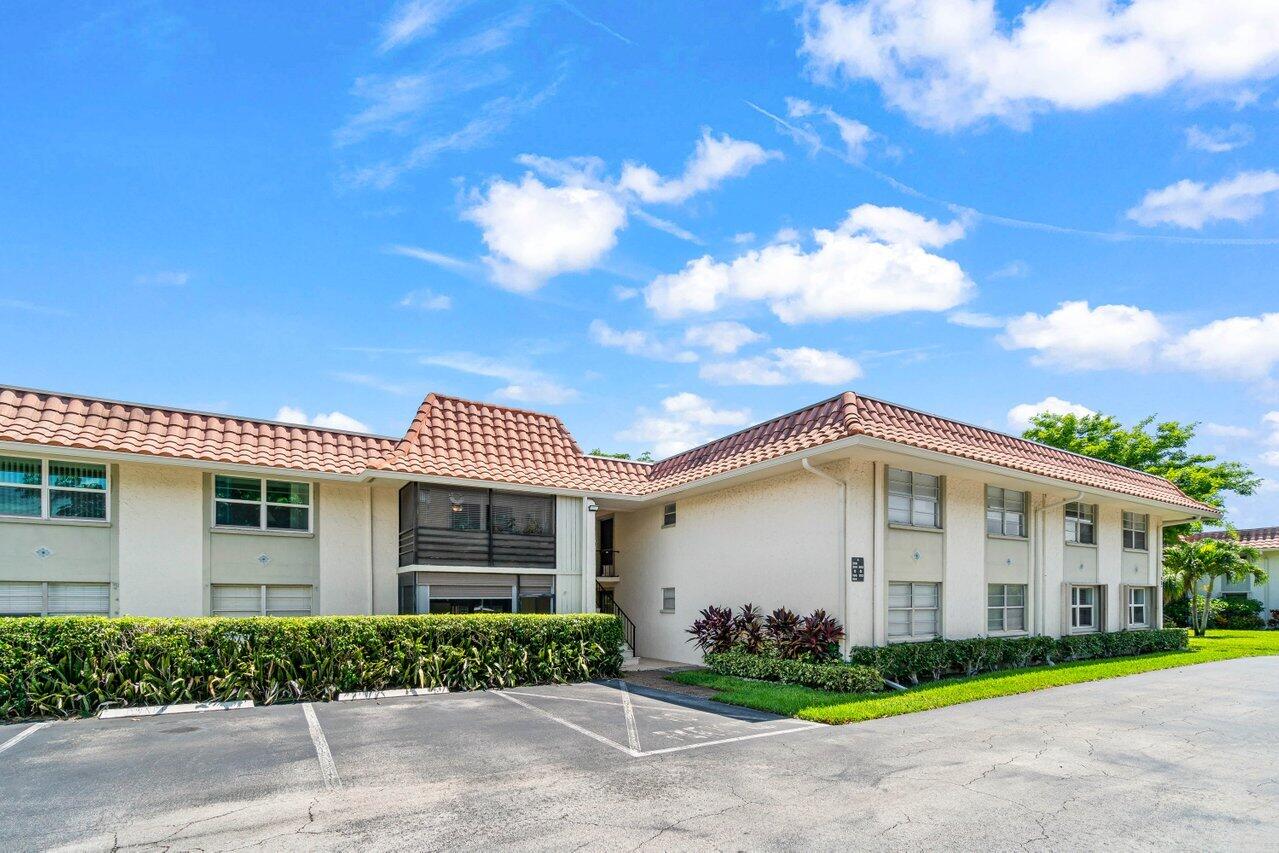 1124 Northwest 13th Street, Unit 204A Boca Raton, FL 33486 - Photo 29 of 30 a front view of a house with garden
