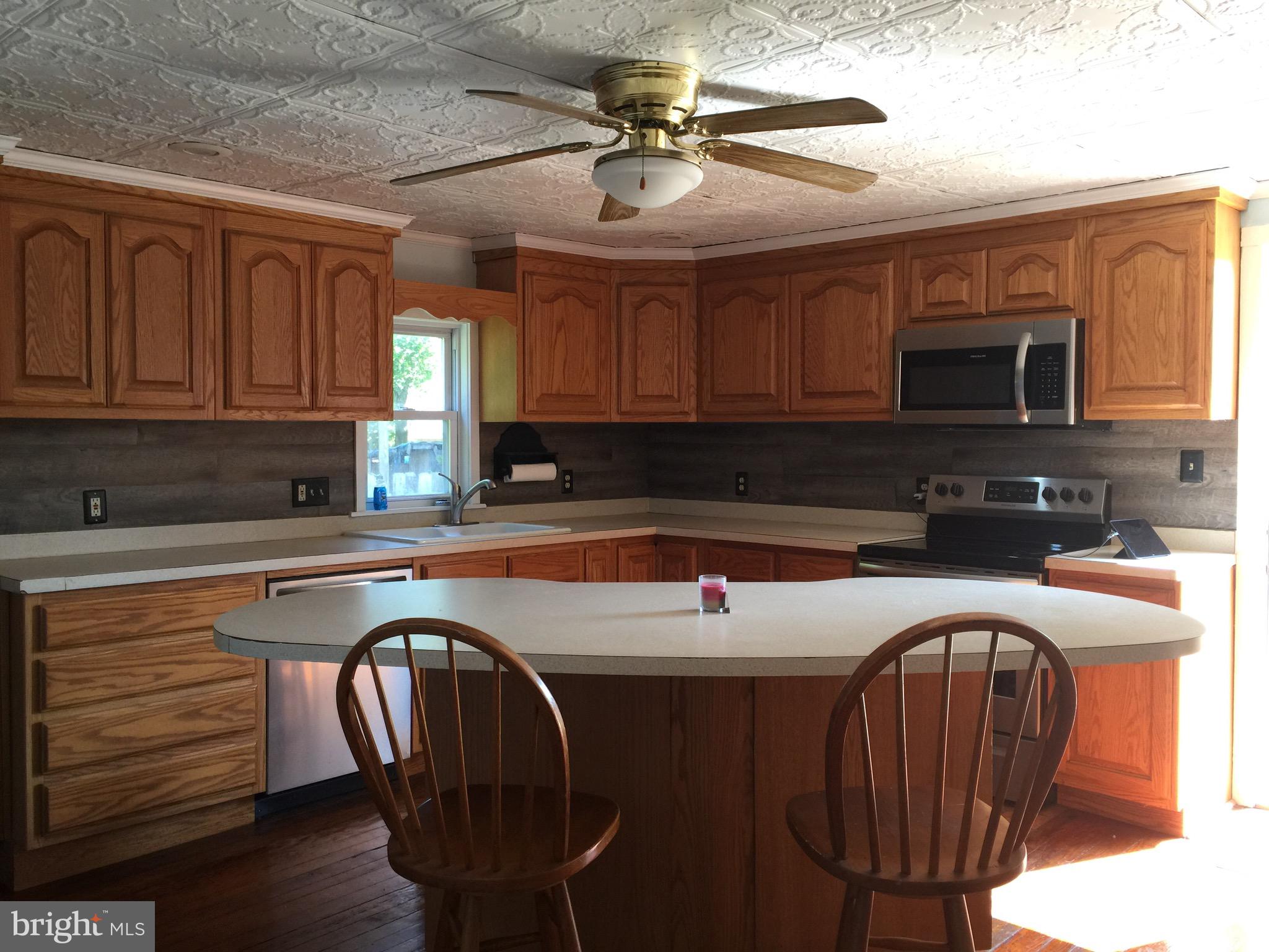 5843 Conover Road Taneytown, MD 21787 - Photo 6 of 11 Kitchen w/ ceiling fan, Island & stools