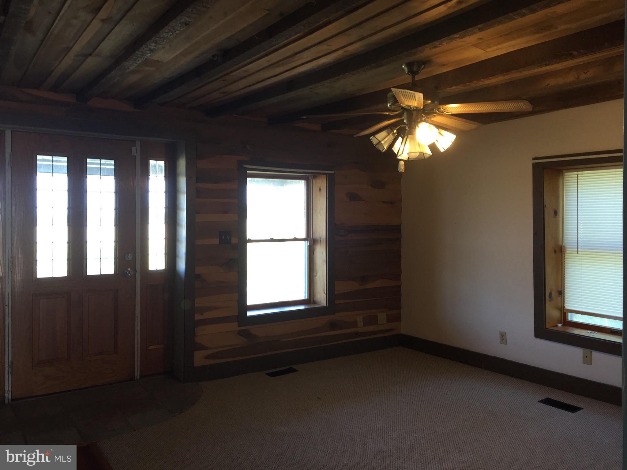 5843 Conover Road Taneytown, MD 21787 - Photo 10 of 11 Living room w/ceiling fan carpet & hardwood