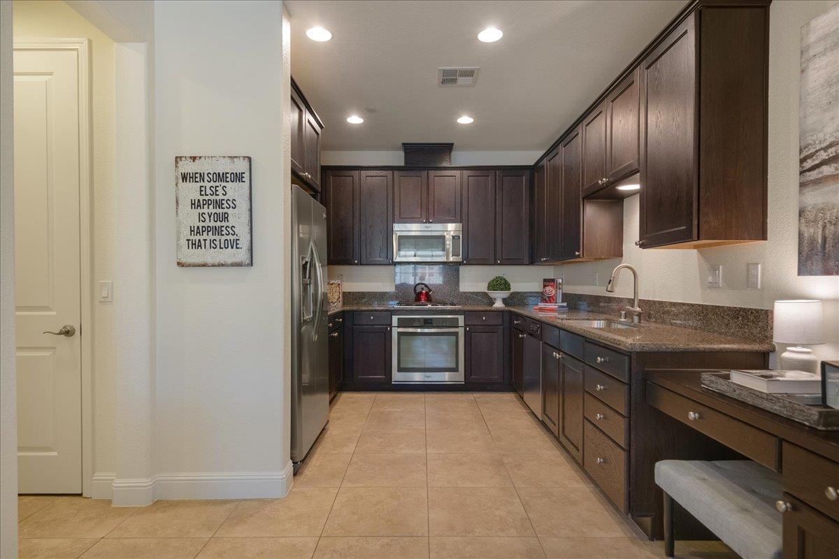 635 True Wind Way, Unit 515 Redwood City, CA 94063 - Photo 16 of 46 a large kitchen with stainless steel appliances granite countertop a stove and a refrigerator