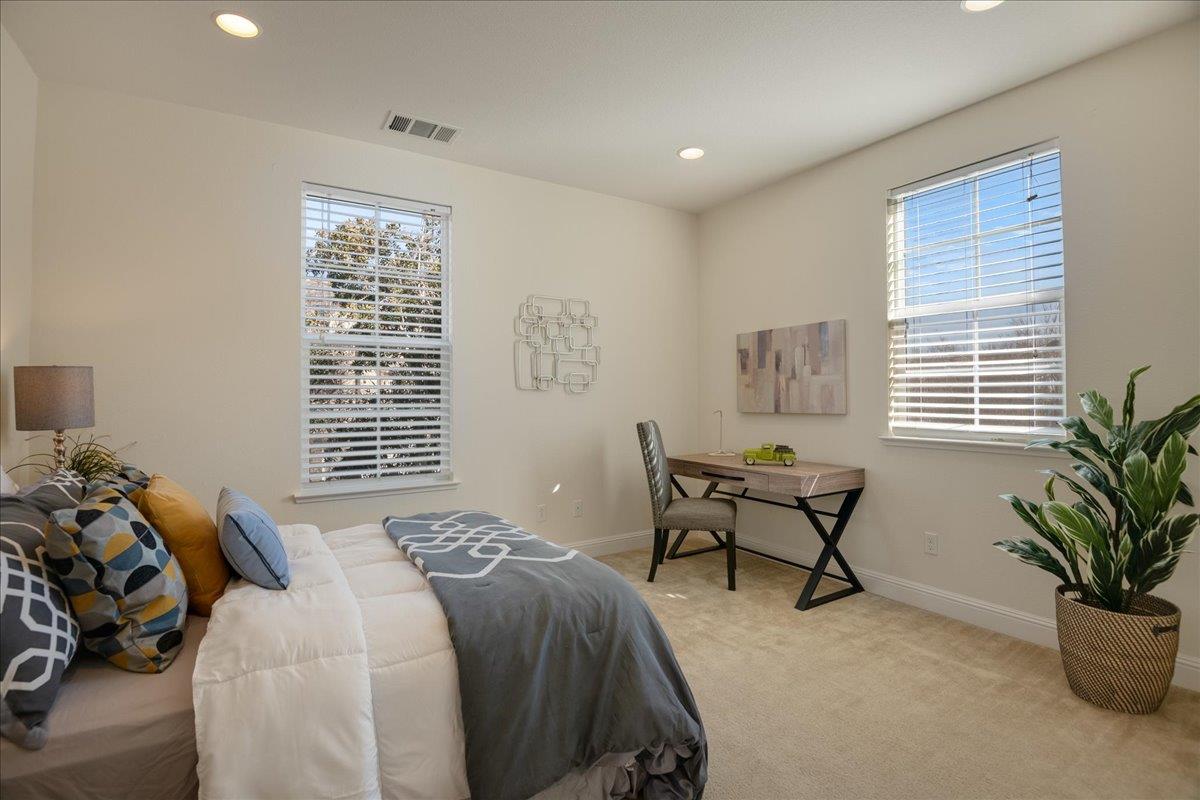 635 True Wind Way, Unit 515 Redwood City, CA 94063 - Photo 23 of 46 a bedroom with a bed and a chair