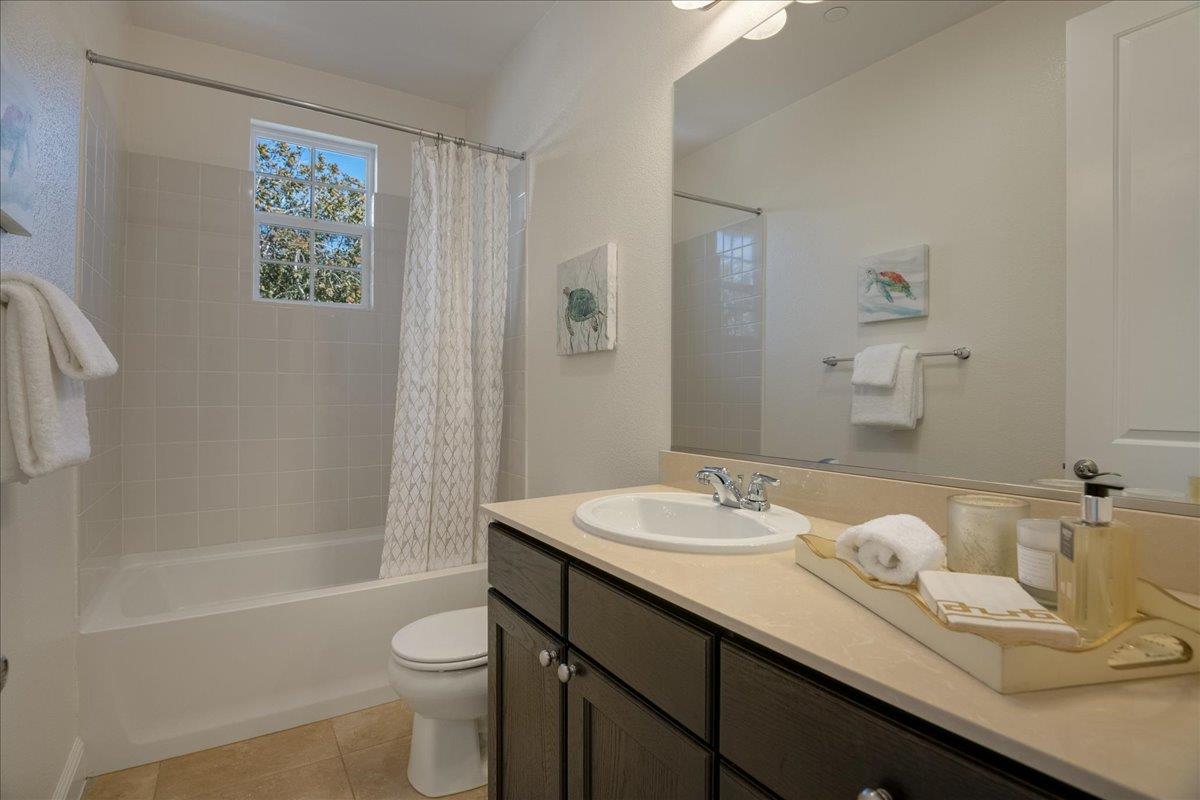 635 True Wind Way, Unit 515 Redwood City, CA 94063 - Photo 25 of 46 a bathroom with a granite countertop sink toilet and shower