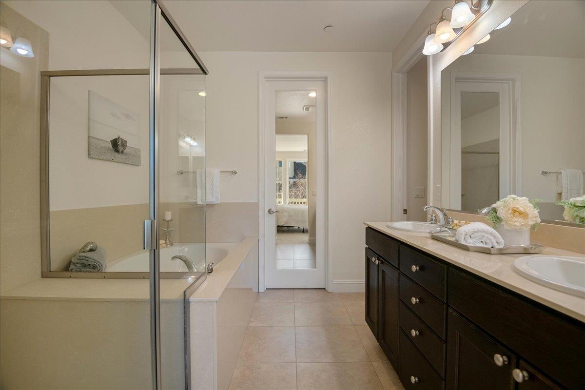 635 True Wind Way, Unit 515 Redwood City, CA 94063 - Photo 32 of 46 a bathroom with a double vanity sink mirror and shower