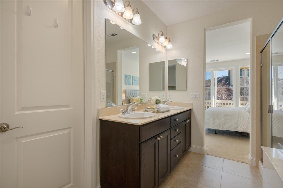635 True Wind Way, Unit 515 Redwood City, CA 94063 - Photo 34 of 46 a bathroom with a sink a large mirror and a shower