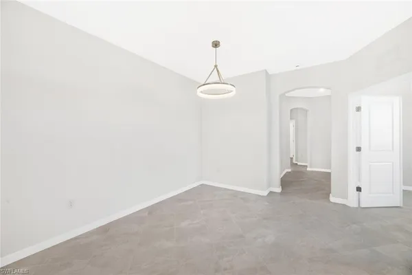 a view of a room with wooden floor and windows