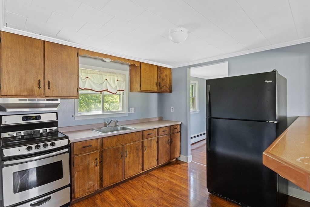 13 Hillcrest Road Scituate, MA 02066 - Photo 12 of 30 a kitchen with a refrigerator sink and stove