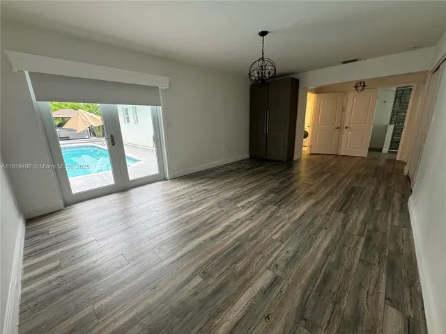 a view of a room with wooden floor and windows