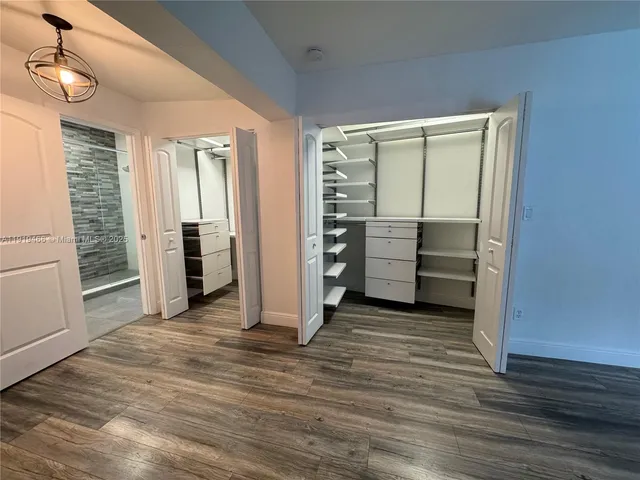 a view of a room with furniture and wooden floor