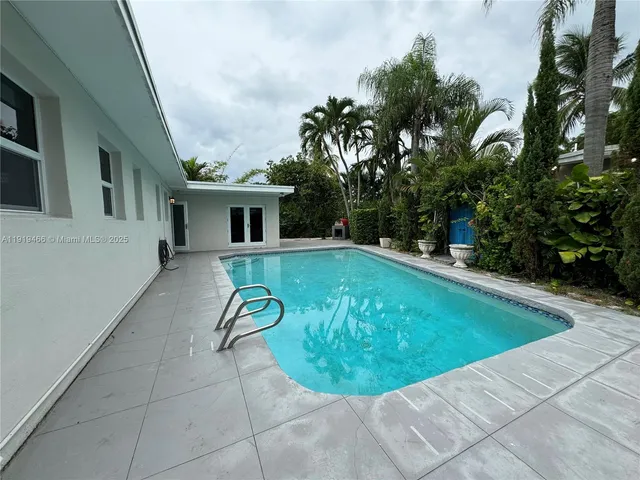 a view of a swimming pool with a patio