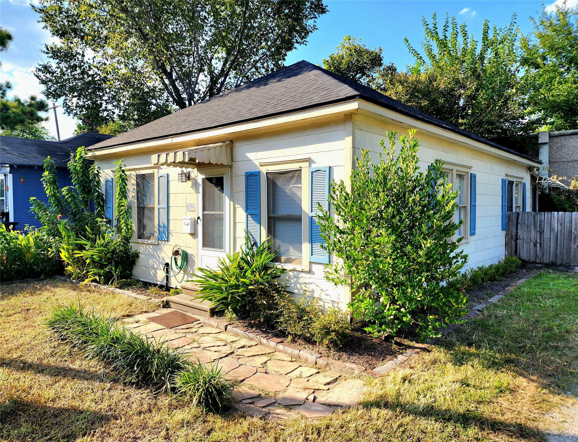 6306 Stillman Street Houston, TX 77007 - Photo 1 of 19 a view of a house with brick walls and a yard with potted plants